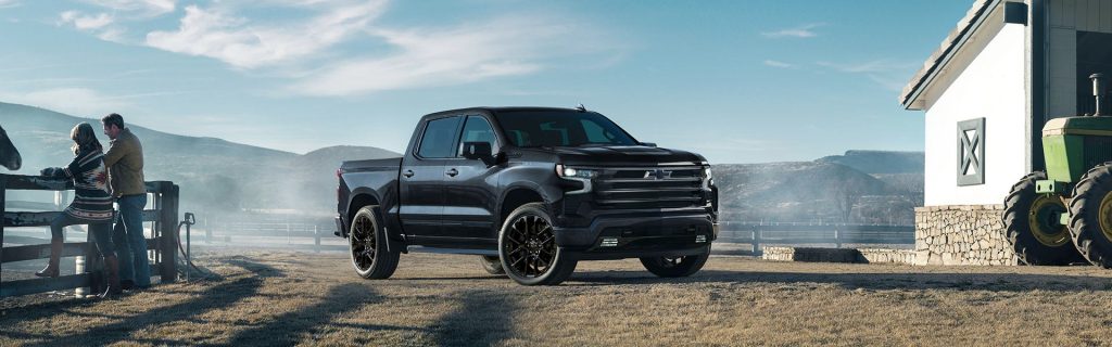 2025 Chevy Silverado 1500 parked in front of a stable