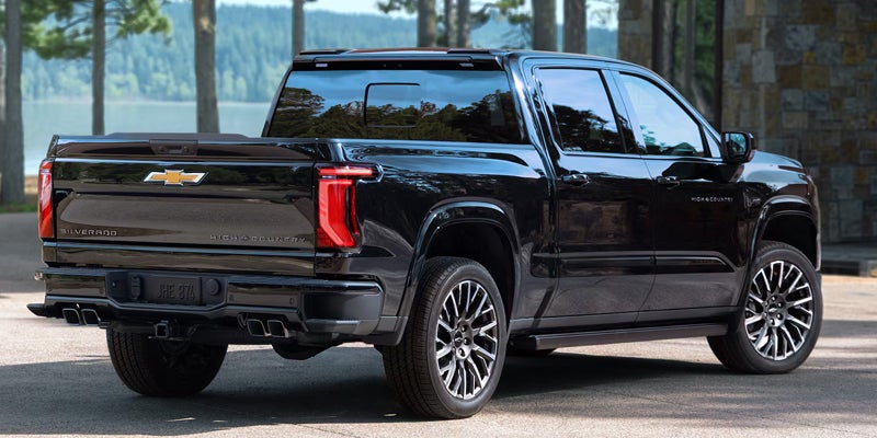 2027 Chevrolet Silverado 1500 in a parking lot, showcasing its sleek design and modern features.